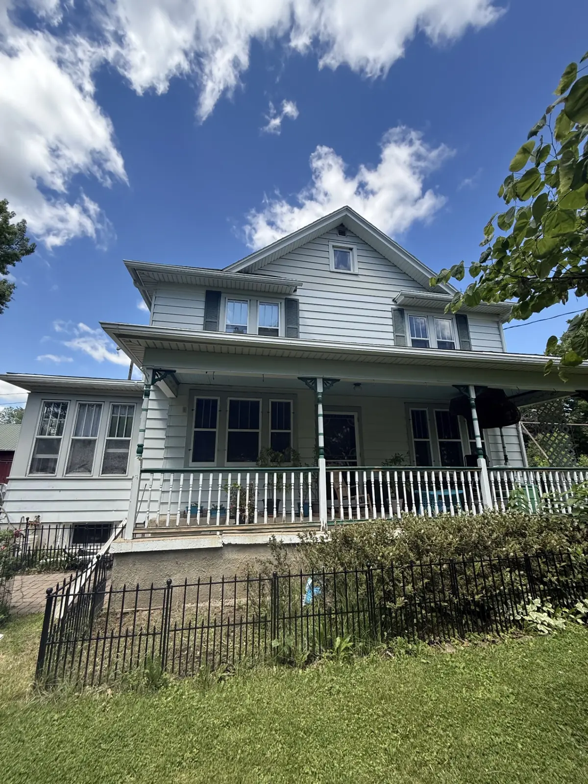 Weathered farmhouse porch before painting