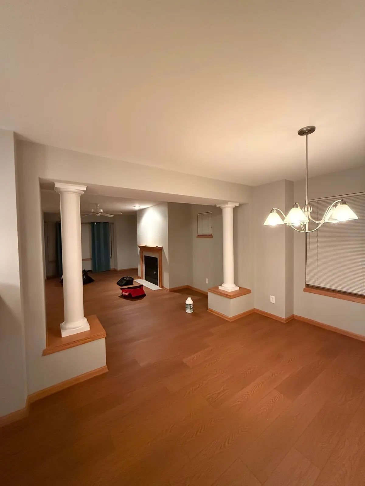 Freshly painted open living and dining room with columns and warm neutral walls