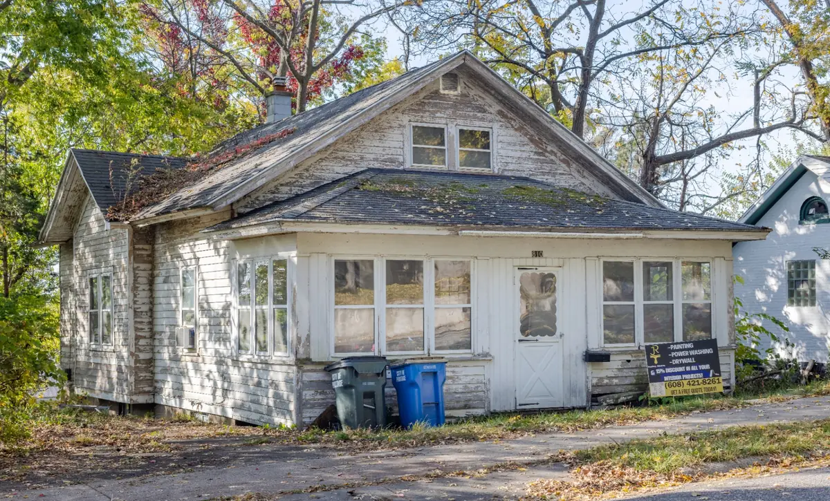 Home exterior before painting — peeling, weathered siding