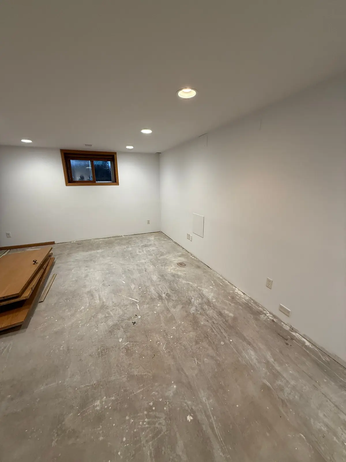 Finished basement with new drywall painted a clean bright white