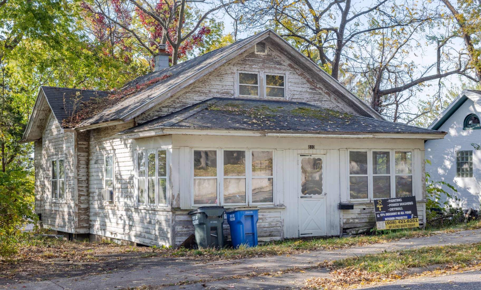 Home exterior before painting — peeling, weathered siding